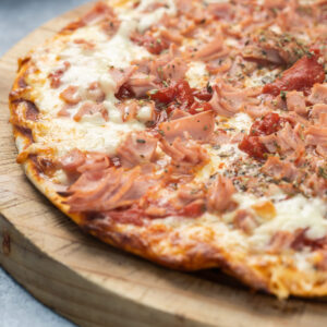 closeup delicious pizza with sliced sausages melted cheese board lights scaled